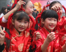 girls in red chinese clothes holding knots
